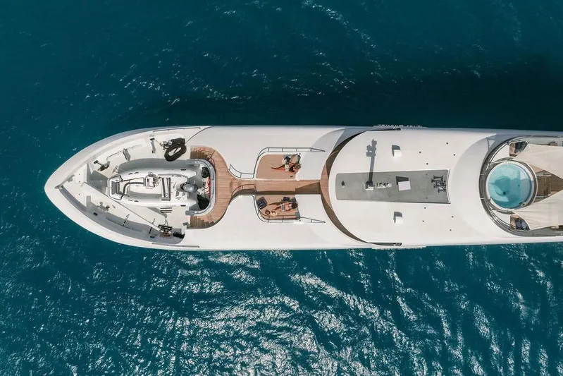 Just Enough Yacht Photos Pics Aerial view of 2012 Ares Custom Marine Custom 141 yacht on blue ocean water.