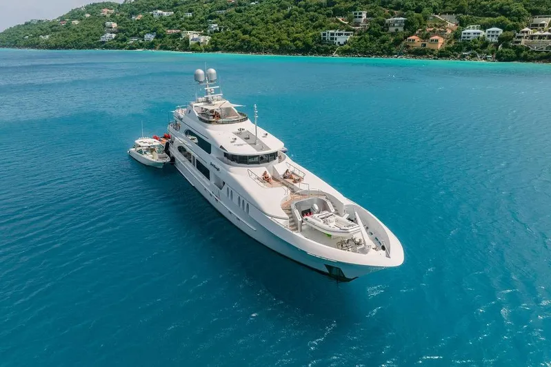 Just Enough Yacht Photos Pics Luxurious 2012 Ares Custom Marine 141 yacht cruising in clear blue waters.