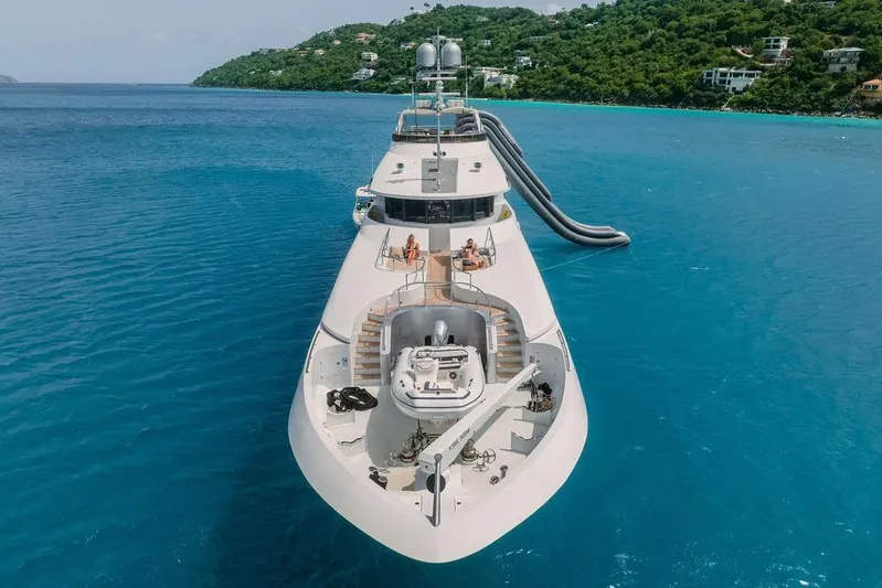 Just Enough Yacht Photos Pics Luxury yacht Ares Custom Marine Custom 141, 2012, anchored in turquoise waters with scenic backdrop.