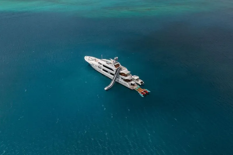 Just Enough Yacht Photos Pics Aerial view of 2012 Ares Custom Marine Custom 141 yacht in clear blue ocean.