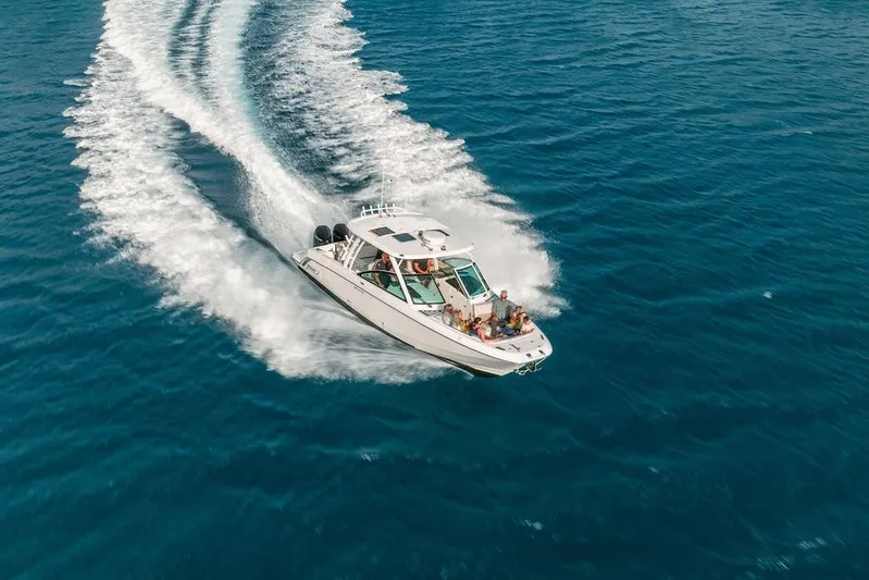 Just Enough Yacht Photos Pics Aerial view of 2012 Ares Custom Marine 141 boat cruising on open water.