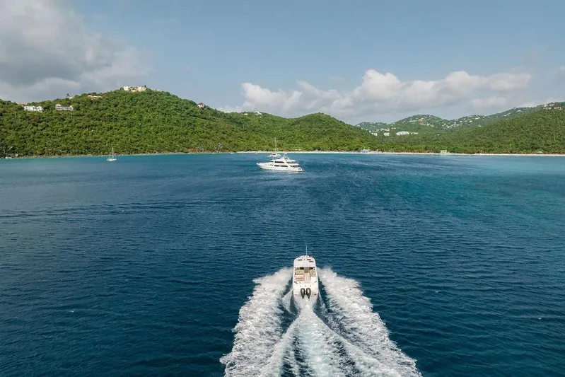 Just Enough Yacht Photos Pics Ares Custom Marine 2012 boat cruising in clear blue waters near lush green hills.