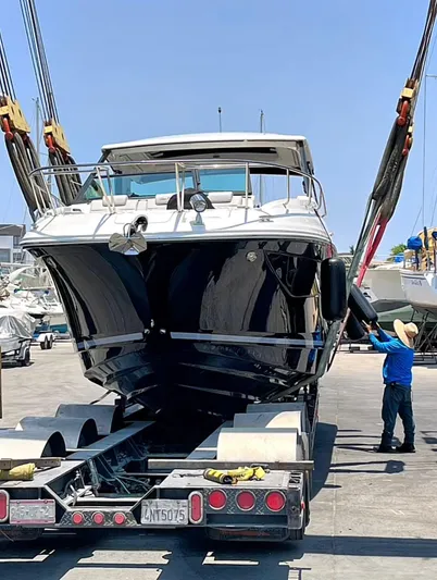 Mi Olvido Yacht Photos Pics 2023 Sea Ray Sundancer 320 Outboard being loaded onto a trailer at a marina.