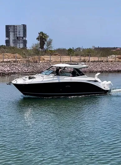 Mi Olvido Yacht Photos Pics 2023 Sea Ray Sundancer 320 Outboard cruising on a calm waterway.