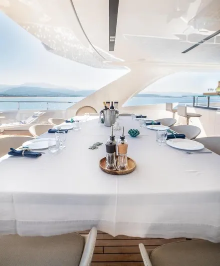 Eden Yacht Photos Pics Luxury dining setup on Maiora 30 Walkaround yacht, 2022 model, with ocean view.