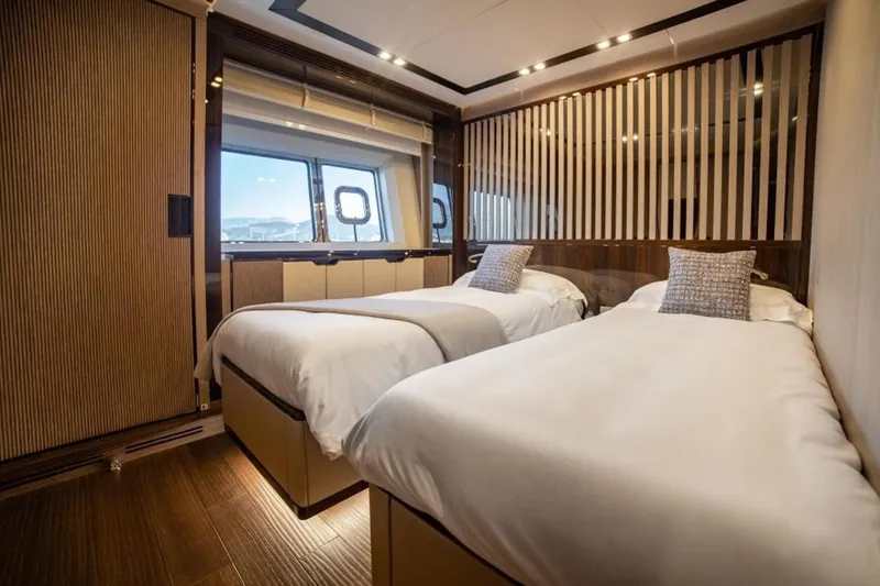 Eden Yacht Photos Pics Luxurious twin bedroom on 2022 Maiora 30 Walkaround yacht with modern design and large windows.