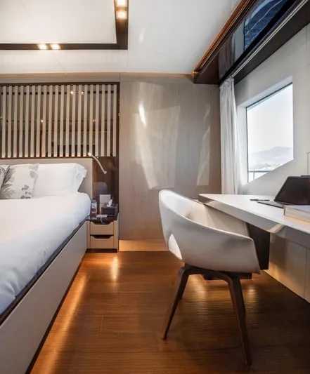 Eden Yacht Photos Pics Luxurious interior of 2022 Maiora 30 Walkaround yacht with modern bedroom and workspace.