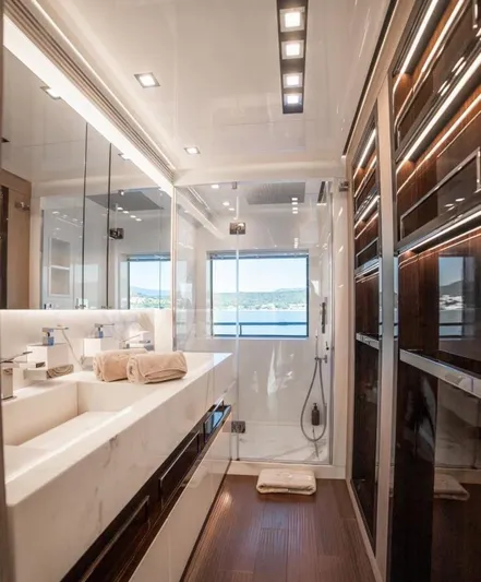 Eden Yacht Photos Pics Luxurious bathroom in 2022 Maiora 30 Walkaround yacht with modern fixtures and scenic window view.