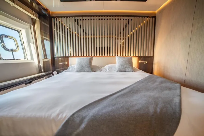 Eden Yacht Photos Pics Luxurious bedroom interior of 2022 Maiora 30 Walkaround yacht with modern design elements.