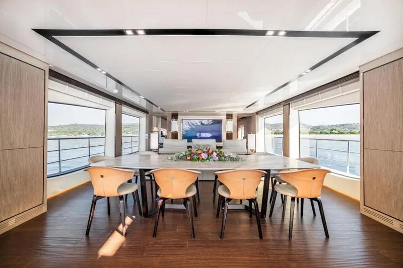Eden Yacht Photos Pics Luxurious interior of 2022 Maiora 30 Walkaround yacht with elegant dining area and scenic views.