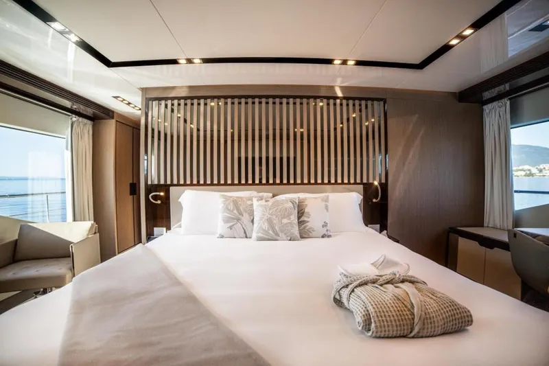 Eden Yacht Photos Pics Luxurious bedroom interior on 2022 Maiora 30 Walkaround yacht, featuring elegant bedding and modern design.