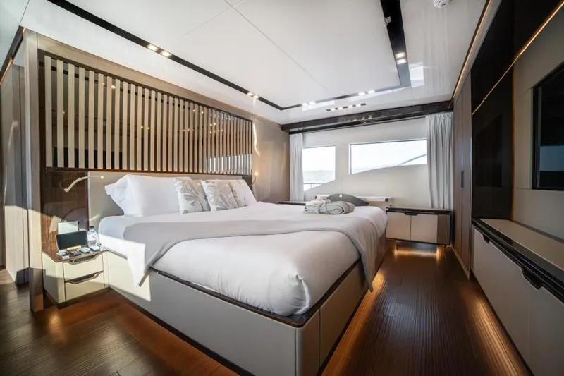 Eden Yacht Photos Pics Luxurious bedroom interior of 2022 Maiora 30 Walkaround yacht with modern design and large windows.