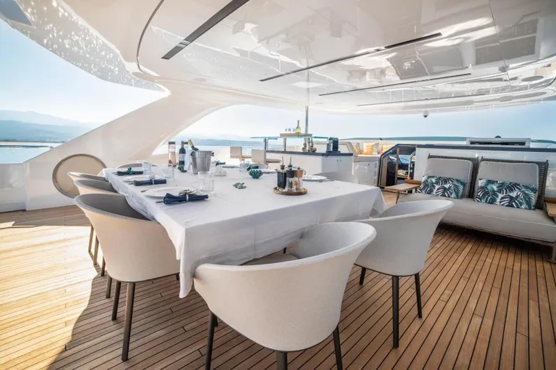 Eden Yacht Photos Pics Luxurious dining area on 2022 Maiora 30 Walkaround yacht with elegant table setting.