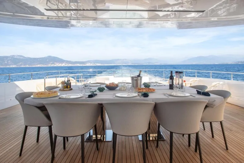 Eden Yacht Photos Pics Luxury dining setup on Maiora 30 Walkaround yacht, 2022, with ocean view.