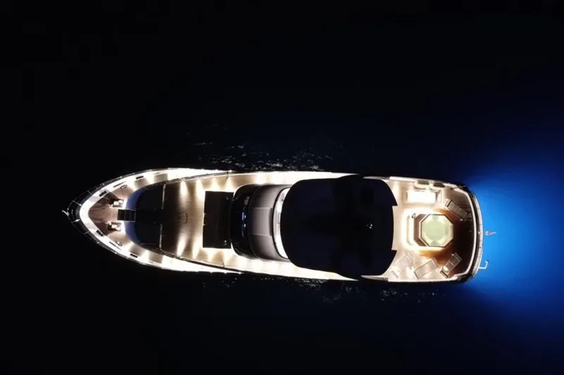 Eden Yacht Photos Pics Aerial view of illuminated 2022 Maiora 30 Walkaround yacht at night.