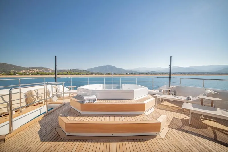 Eden Yacht Photos Pics Luxurious Maiora 30 Walkaround yacht deck with hot tub, 2022 model, scenic ocean view.