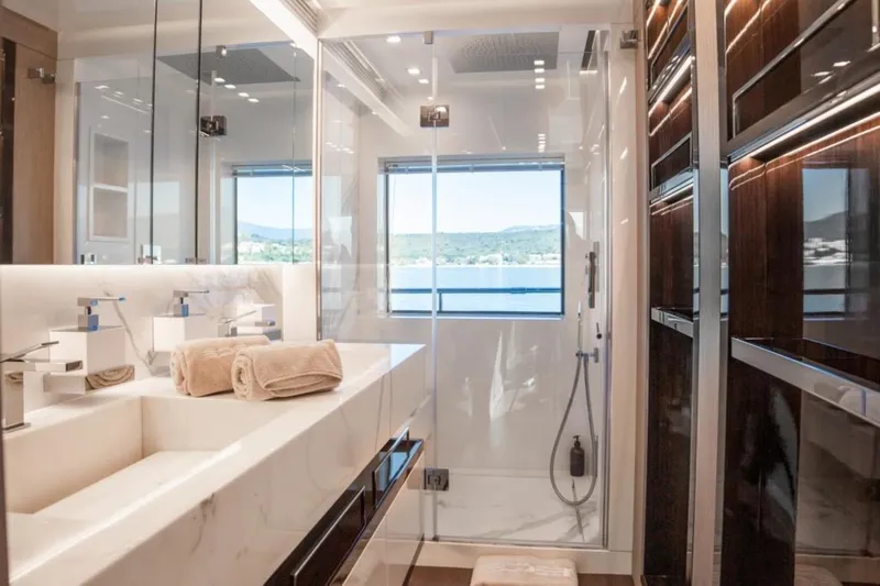 Eden Yacht Photos Pics Luxurious bathroom on 2022 Maiora 30 Walkaround yacht with modern fixtures and scenic window view.