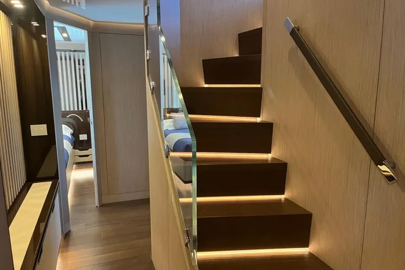 Eden Yacht Photos Pics Luxurious interior of 2022 Maiora 30 Walkaround yacht with modern staircase and ambient lighting.