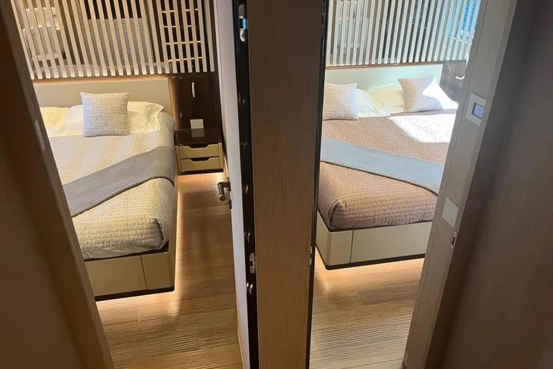 Eden Yacht Photos Pics Luxurious twin bedrooms on a 2022 Maiora 30 Walkaround yacht, featuring modern design and ambient lighting.
