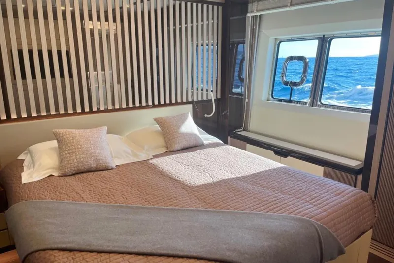 Eden Yacht Photos Pics Luxurious bedroom interior of 2022 Maiora 30 Walkaround yacht with ocean view.