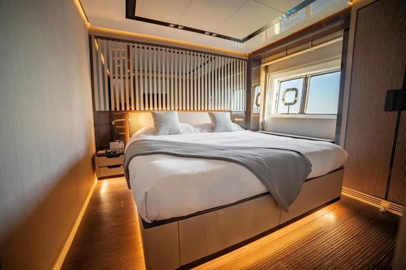 Eden Yacht Photos Pics Luxurious bedroom interior on 2022 Maiora 30 Walkaround yacht, featuring elegant lighting and modern design.