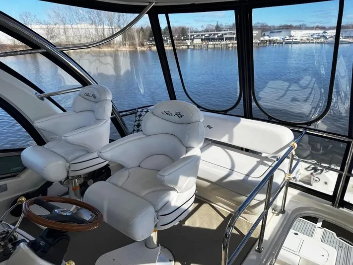  Yacht Photos Pics 2005 Sea Ray 500 Sedan Bridge interior with white seating and panoramic water view.