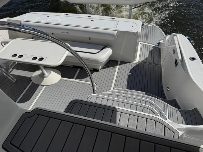  Yacht Photos Pics 2005 Sea Ray 500 Sedan Bridge yacht deck with seating and table, cruising on water.