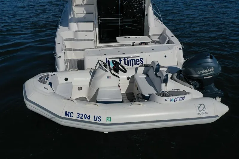  Yacht Photos Pics 2005 Sea Ray 500 Sedan Bridge with Zodiac tender and Yamaha outboard motor on water.
