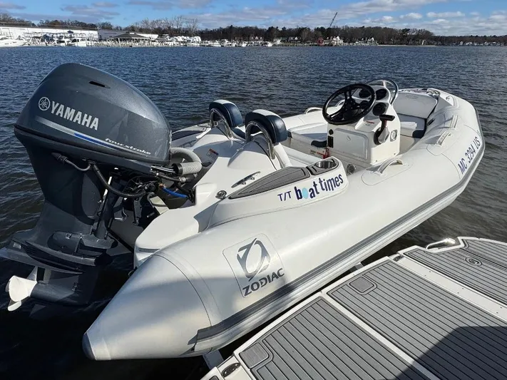  Yacht Photos Pics A Zodiac inflatable boat with Yamaha motor docked on a sunny day.