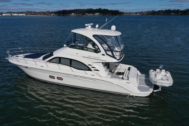  Yacht Photos Pics 2005 Sea Ray 500 Sedan Bridge yacht cruising on calm waters.