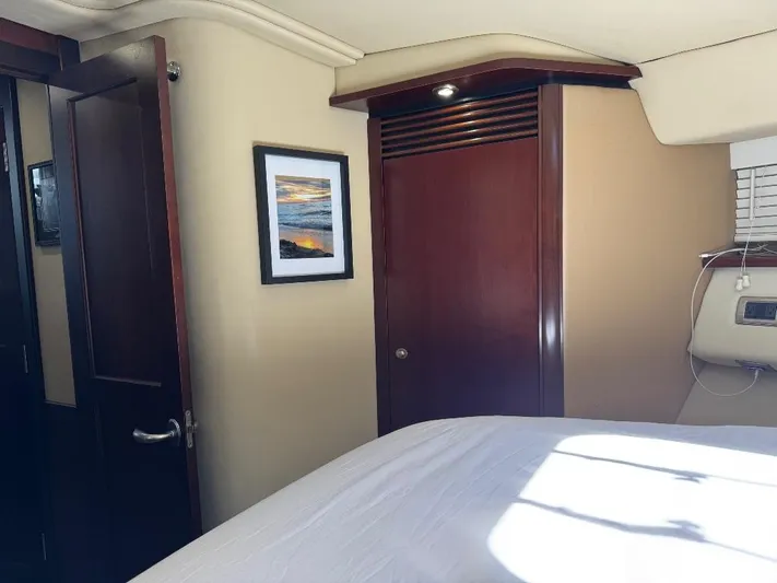  Yacht Photos Pics Interior of 2005 Sea Ray 500 Sedan Bridge with wood paneling and framed artwork.