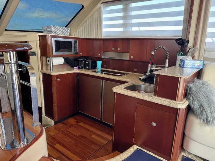  Yacht Photos Pics Luxurious kitchen interior of 2005 Sea Ray 500 Sedan Bridge yacht with modern amenities.