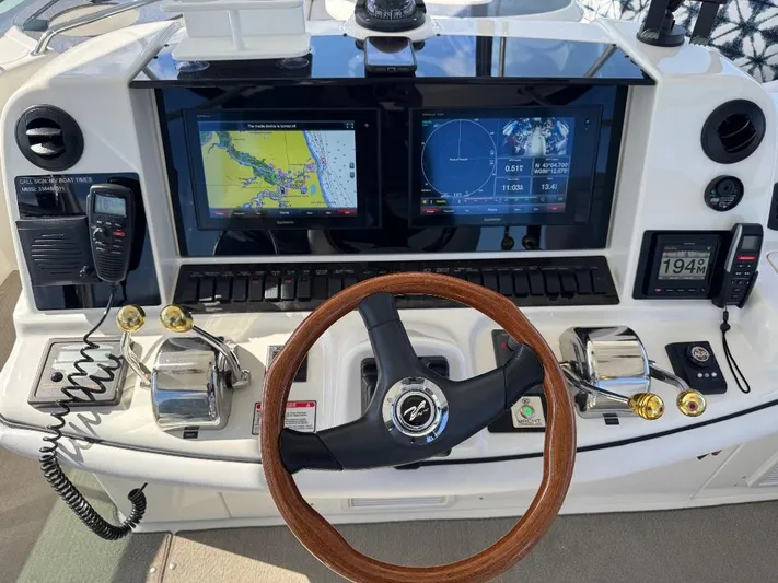  Yacht Photos Pics 2005 Sea Ray 500 Sedan Bridge helm with dual navigation screens and wooden steering wheel.