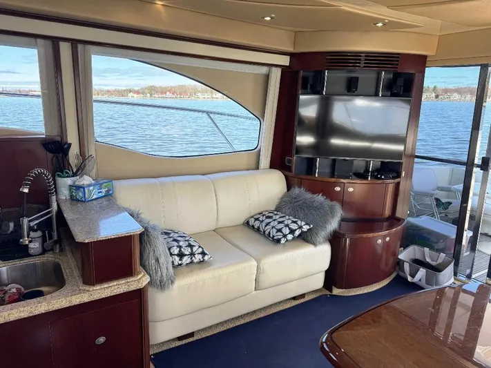  Yacht Photos Pics Luxurious interior of 2005 Sea Ray 500 Sedan Bridge yacht with sofa and TV.