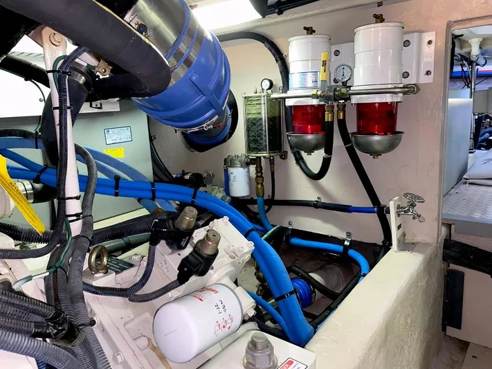  Yacht Photos Pics Engine room of 2005 Sea Ray 500 Sedan Bridge with blue hoses and fuel filters.