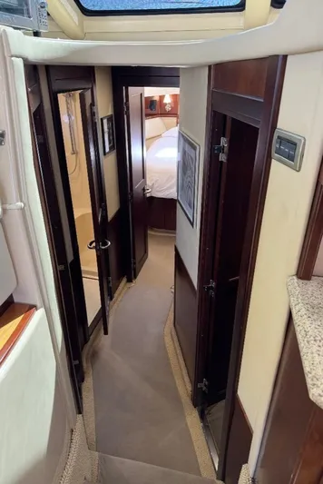  Yacht Photos Pics Interior hallway of 2005 Sea Ray 500 Sedan Bridge yacht, featuring elegant wood finishes.