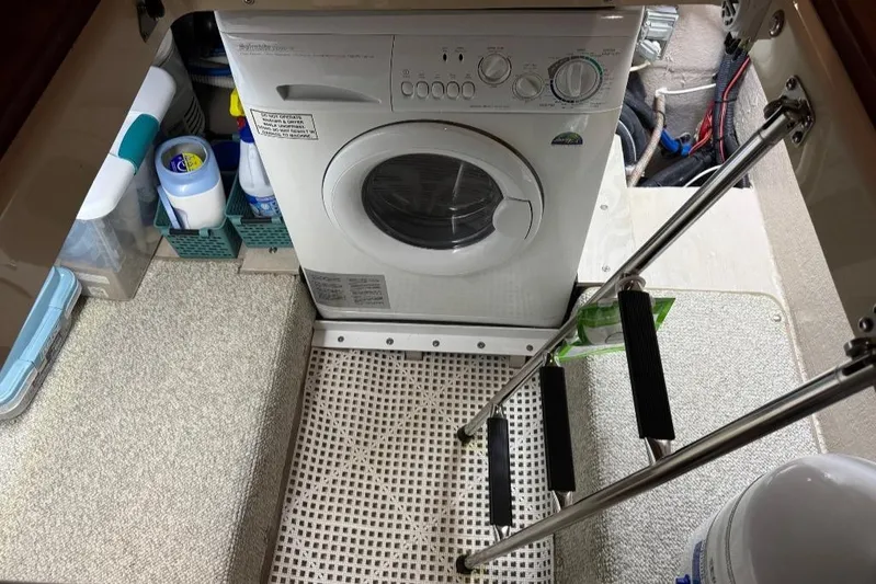  Yacht Photos Pics Laundry area on 2005 Sea Ray 500 Sedan Bridge yacht with washing machine and cleaning supplies.