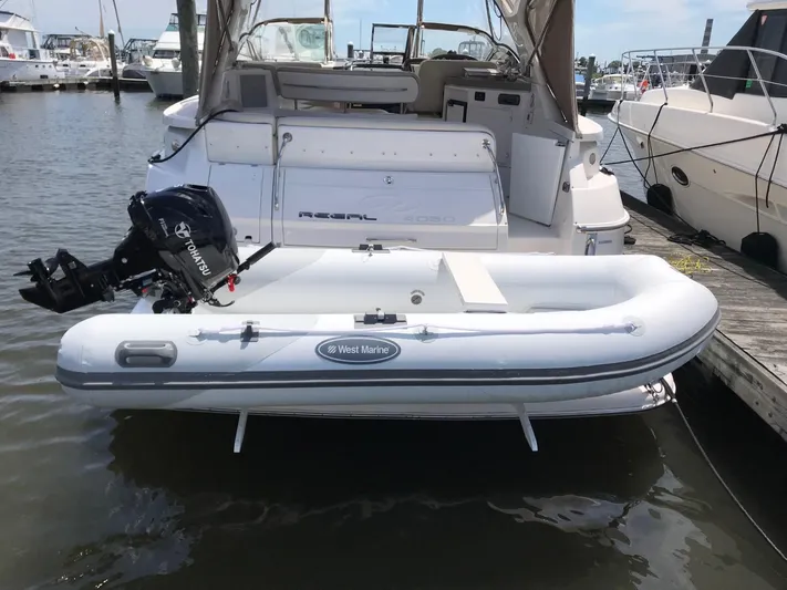  Yacht Photos Pics 2009 Regal Commodore 4060 yacht with inflatable West Marine dinghy at marina.