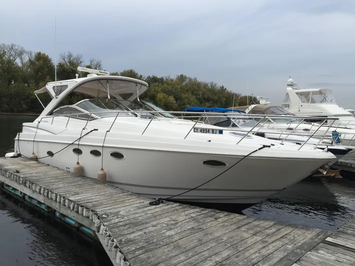 Yacht Photos Pics 2009 Regal Commodore 4060 yacht docked at a marina, surrounded by trees and water.