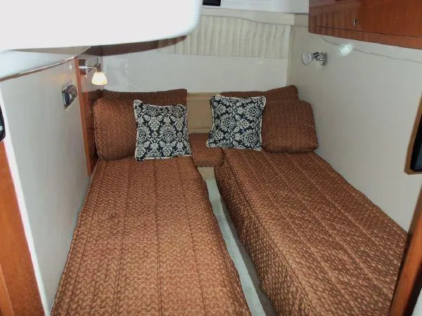  Yacht Photos Pics Twin beds in 2009 Regal Commodore 4060 cabin with patterned pillows and brown bedding.