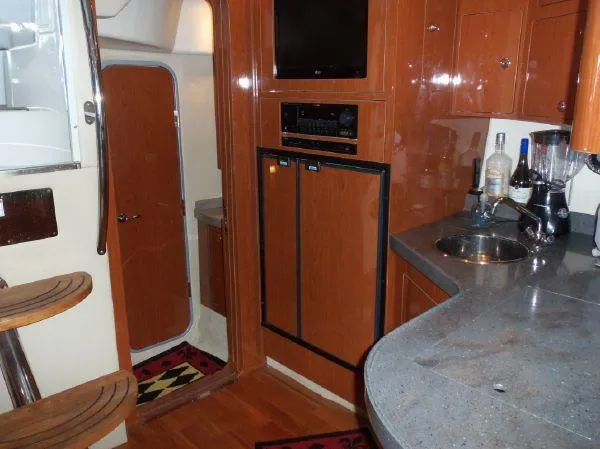  Yacht Photos Pics Interior of 2009 Regal Commodore 4060 yacht with kitchenette and wooden cabinetry.