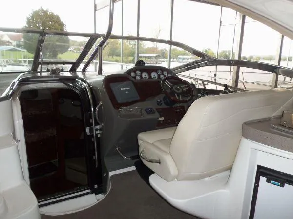  Yacht Photos Pics 2009 Regal Commodore 4060 boat interior with helm, steering wheel, and seating.