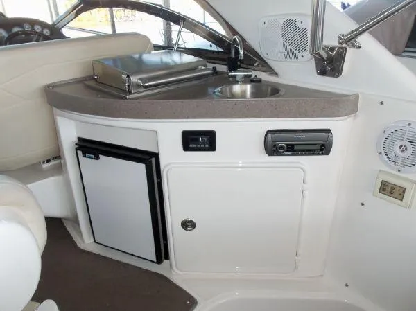  Yacht Photos Pics 2009 Regal Commodore 4060 yacht interior with kitchenette, sink, and mini fridge.