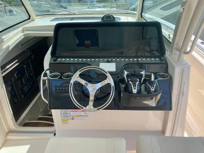 Yacht Photos Pics 2025 Grady-White Canyon 386 helm with modern controls and steering wheel.