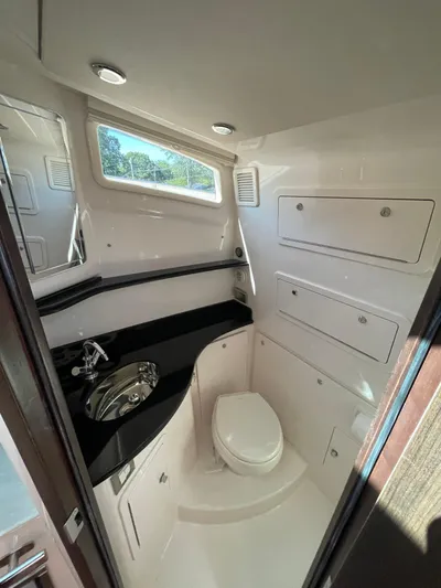  Yacht Photos Pics 2025 Grady-White Canyon 386 boat interior bathroom with modern fixtures and ample storage.