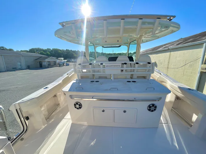  Yacht Photos Pics 2025 Grady-White Canyon 386 boat interior with seating and storage, under clear blue sky.