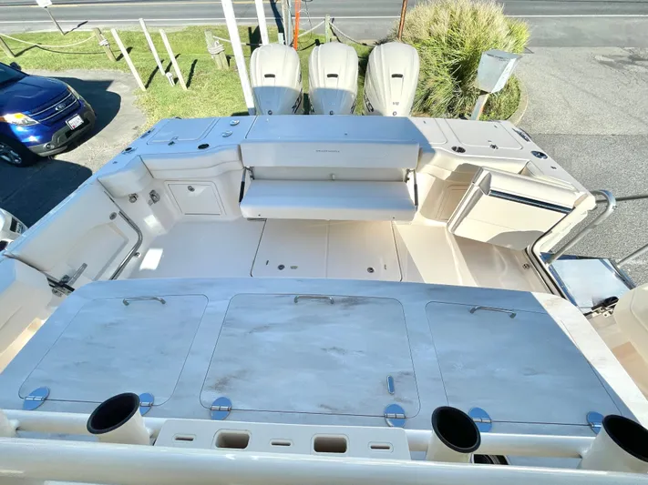  Yacht Photos Pics 2025 Grady-White Canyon 386 boat deck with seating and storage compartments.