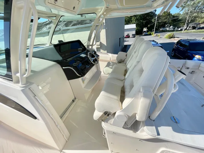  Yacht Photos Pics 2025 Grady-White Canyon 386 boat interior with white seating and modern helm.