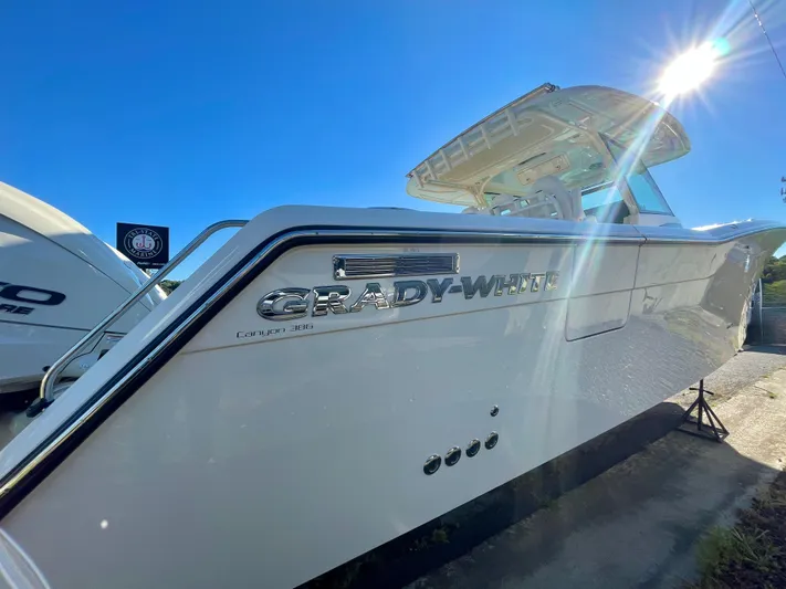  Yacht Photos Pics 2025 Grady-White Canyon 386 boat in sunlight, showcasing sleek design and branding.