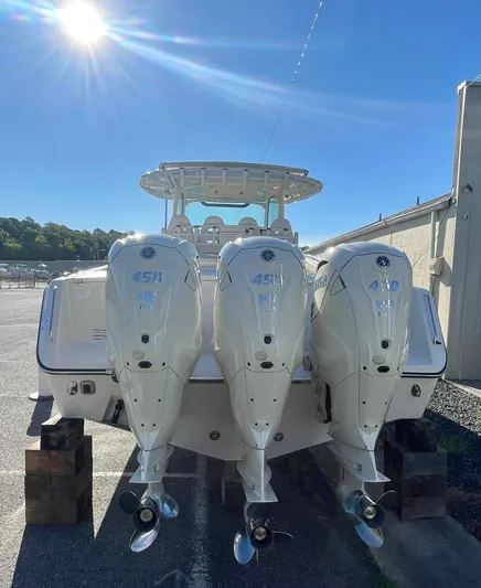  Yacht Photos Pics 2025 Grady-White Canyon 386 boat with triple 450 HP engines under sunny sky.